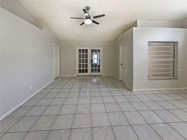 8812 Bayaud Dr, Tampa, FL 33626 - spare room featuring a ceiling fan, french doors, baseboards, light tile patterned floors, and vaulted ceiling