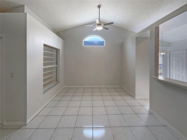 8812 Bayaud Dr, Tampa, FL 33626 - empty room with ceiling fan, vaulted ceiling, a textured ceiling, light tile patterned flooring, and built in shelves