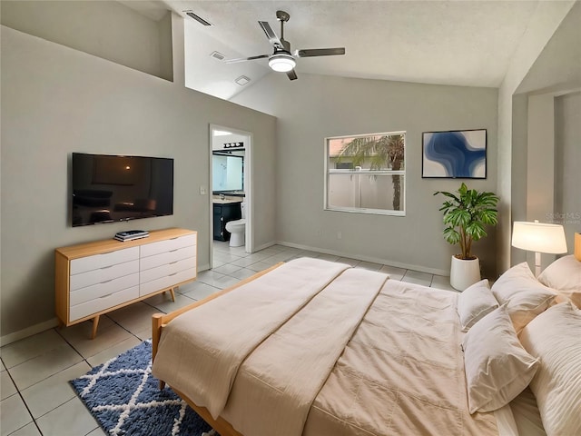 8812 Bayaud Dr, Tampa, FL 33626 - bedroom featuring light tile patterned flooring, lofted ceiling, ensuite bath, and baseboards