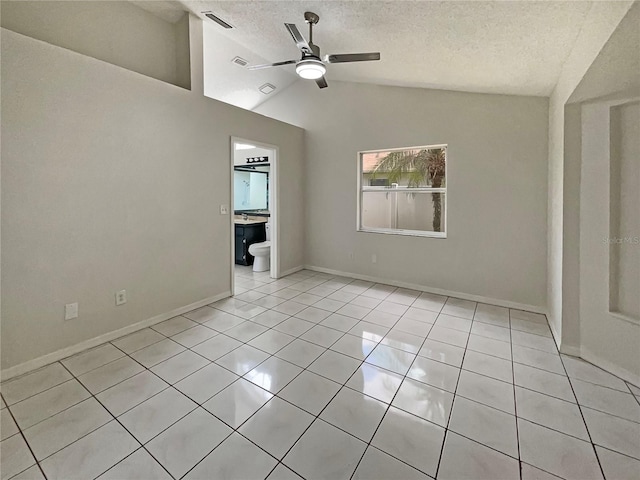 8812 Bayaud Dr, Tampa, FL 33626 - spare room featuring a ceiling fan, a textured ceiling, lofted ceiling, light tile patterned floors, and baseboards