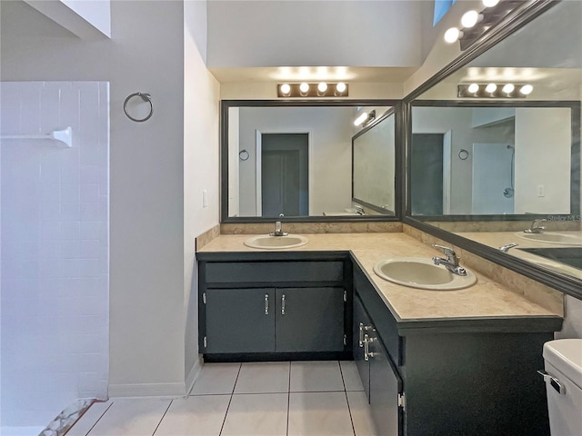 8812 Bayaud Dr, Tampa, FL 33626 - full bathroom featuring tile patterned floors, double vanity, baseboards, and tiled shower