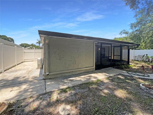 8812 Bayaud Dr, Tampa, FL 33626 - rear view of house with a fenced backyard, a sunroom, and a patio area