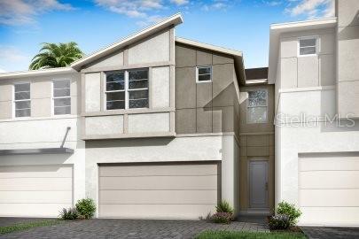 3424 Timber Crossing Ave, Brandon, FL 33511 - view of front of property with stucco siding, an attached garage, and driveway