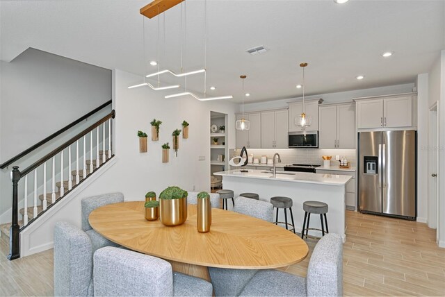 3424 Timber Crossing Ave, Brandon, FL 33511 - dining room featuring light wood-type flooring, stairway, and recessed lighting