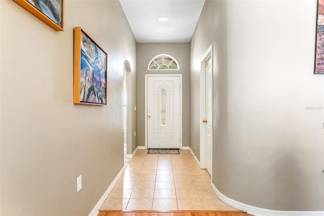 12746 Standbridge Dr, Riverview, FL 33579 - doorway to outside with baseboards, light tile patterned floors, and arched walkways