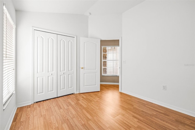 12746 Standbridge Dr, Riverview, FL 33579 - unfurnished bedroom with light wood-type flooring, lofted ceiling, baseboards, and a closet