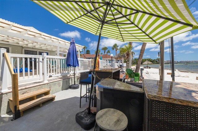 3595 41st Ln S Unit L, Saint Petersburg, FL 33711 - view of patio featuring a water view and a pergola