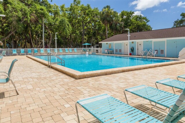 3595 41st Ln S Unit L, Saint Petersburg, FL 33711 - community pool with a patio and view of scattered trees