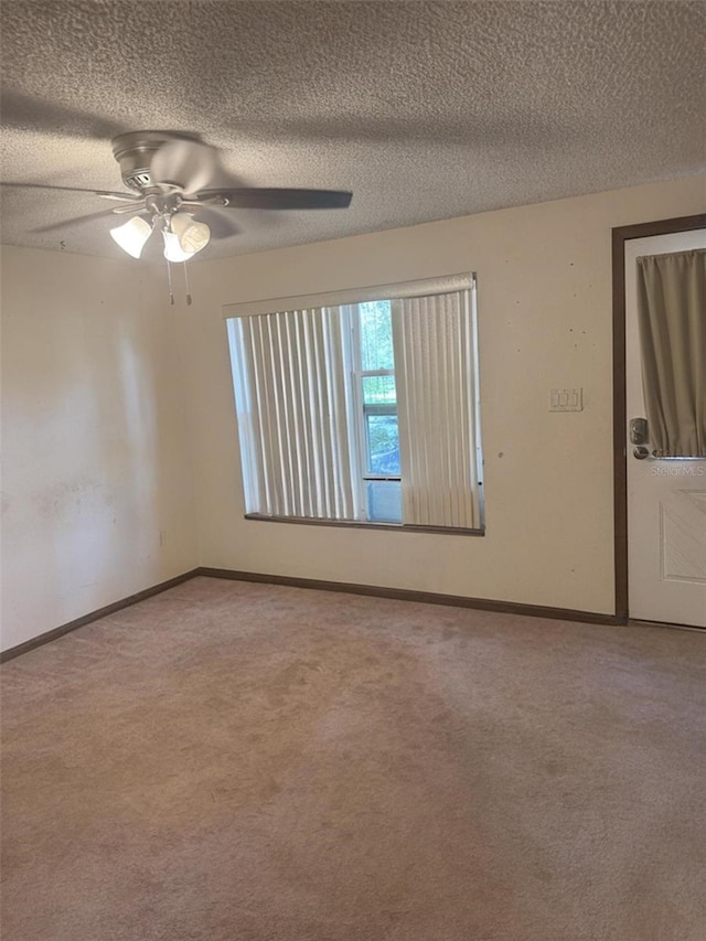 2220 Woods Trl, Lakeland, FL 33809 - carpeted spare room with baseboards, ceiling fan, and a textured ceiling