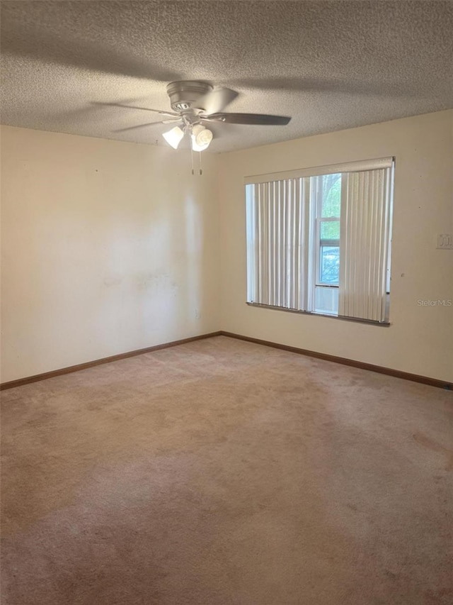 2220 Woods Trl, Lakeland, FL 33809 - empty room with light carpet, ceiling fan, a textured ceiling, and baseboards