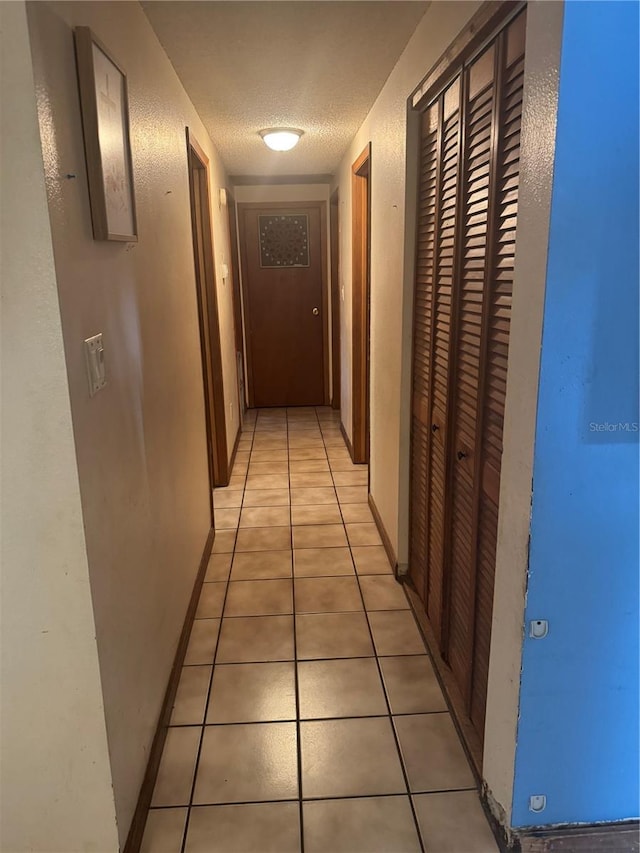 2220 Woods Trl, Lakeland, FL 33809 - hall featuring light tile patterned floors and a textured ceiling