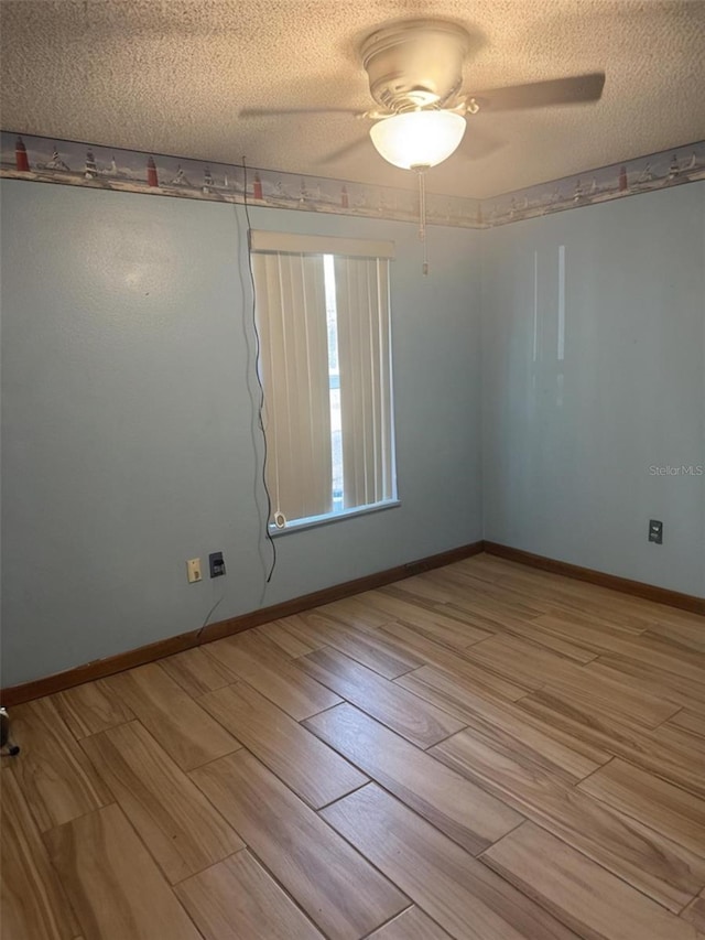 2220 Woods Trl, Lakeland, FL 33809 - unfurnished room featuring wood finish floors, a textured ceiling, a ceiling fan, and baseboards