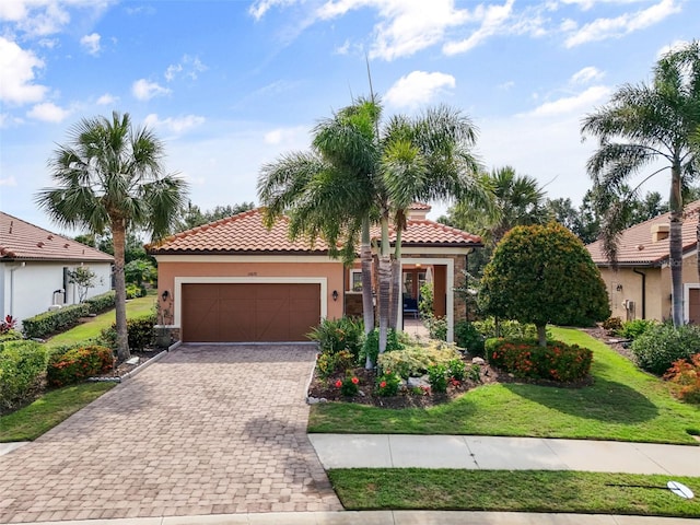 12672 Fontana Loop, Bradenton, FL 34211 - mediterranean / spanish-style home with a garage, stucco siding, stone siding, decorative driveway, and a tile roof