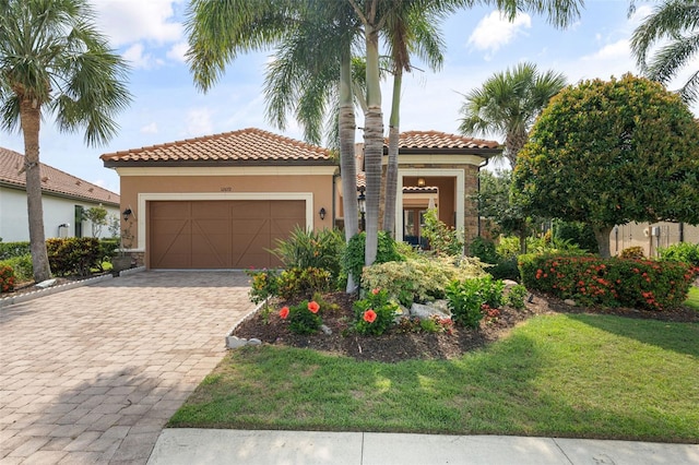 12672 Fontana Loop, Bradenton, FL 34211 - mediterranean / spanish-style house with stone siding, stucco siding, decorative driveway, a garage, and a front yard