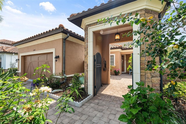 12672 Fontana Loop, Bradenton, FL 34211 - view of exterior entry featuring stucco siding, an attached garage, and a tiled roof