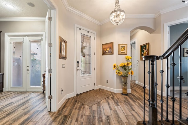 12672 Fontana Loop, Bradenton, FL 34211 - entryway with arched walkways, wood finished floors, crown molding, and baseboards
