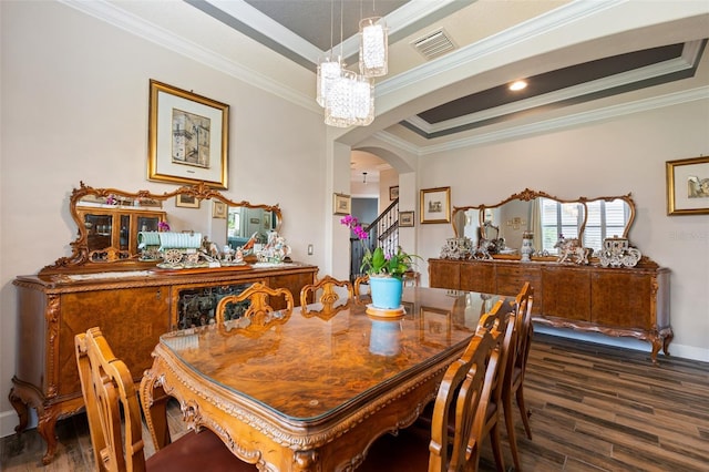 12672 Fontana Loop, Bradenton, FL 34211 - dining area featuring ornamental molding, dark wood-style floors, arched walkways, a tray ceiling, and baseboards