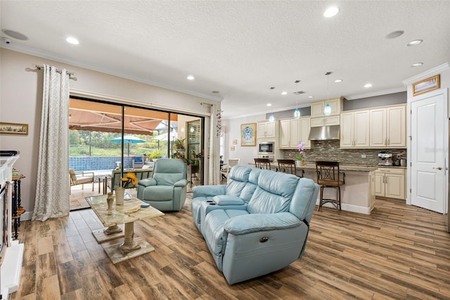 12672 Fontana Loop, Bradenton, FL 34211 - living room with crown molding, wood finished floors, a textured ceiling, and recessed lighting