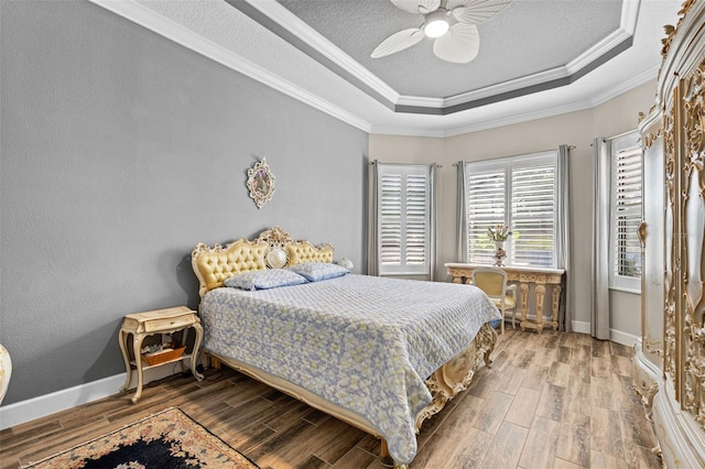12672 Fontana Loop, Bradenton, FL 34211 - bedroom featuring a raised ceiling, wood finished floors, a ceiling fan, baseboards, and crown molding