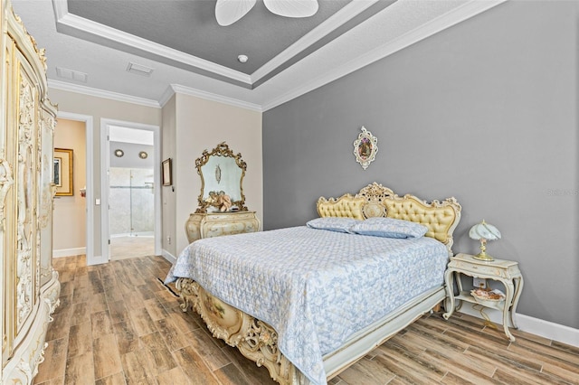 12672 Fontana Loop, Bradenton, FL 34211 - bedroom with a tray ceiling, wood finished floors, baseboards, and ornamental molding