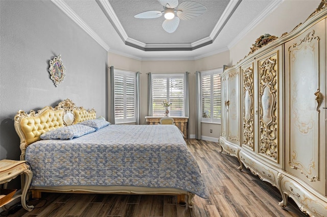 12672 Fontana Loop, Bradenton, FL 34211 - bedroom featuring a tray ceiling, wood finished floors, ceiling fan, ornamental molding, and a textured ceiling
