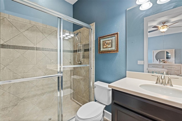 12672 Fontana Loop, Bradenton, FL 34211 - bathroom with toilet, vanity, a stall shower, a textured wall, and a ceiling fan