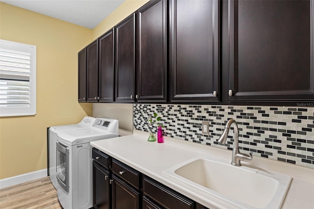 12672 Fontana Loop, Bradenton, FL 34211 - laundry room featuring washer and dryer, cabinet space, baseboards, and light wood-style floors