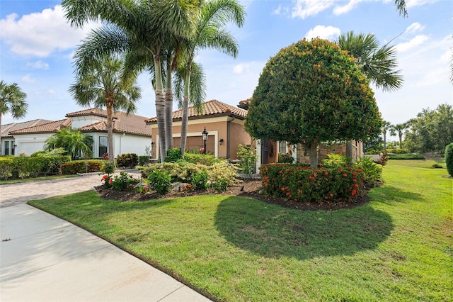 12672 Fontana Loop, Bradenton, FL 34211 - mediterranean / spanish home with a tiled roof, a front yard, driveway, stucco siding, and an attached garage
