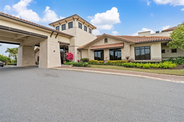 12672 Fontana Loop, Bradenton, FL 34211 - mediterranean / spanish-style house with stone siding, a tile roof, and stucco siding