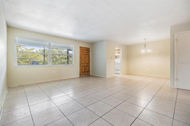1485 Lakeview Rd Unit 19, Clearwater, FL 33756 - spare room with a chandelier, light tile patterned flooring, and baseboards