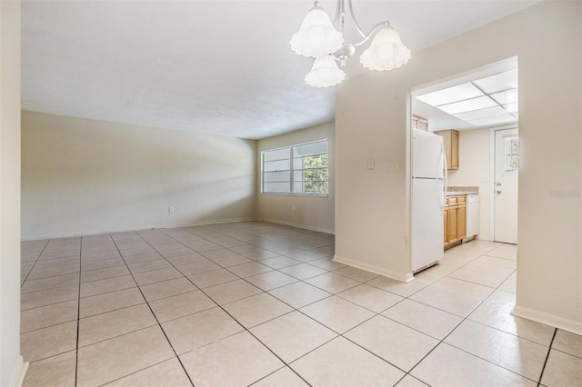 1485 Lakeview Rd Unit 19, Clearwater, FL 33756 - unfurnished room with light tile patterned flooring, a chandelier, and baseboards
