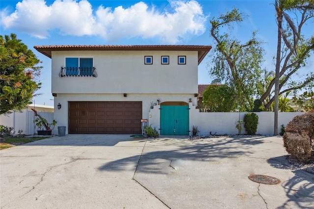 11285 8th St E, Treasure Island, FL 33706 - mediterranean / spanish house featuring an attached garage, stucco siding, concrete driveway, and a tiled roof