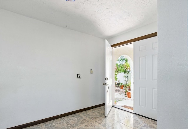 11285 8th St E, Treasure Island, FL 33706 - foyer entrance with baseboards and a textured ceiling