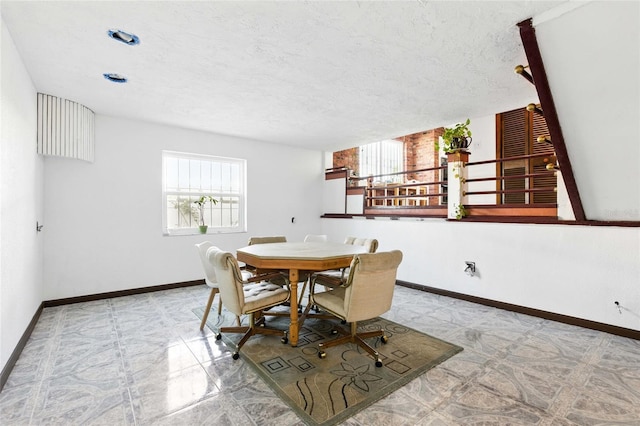 11285 8th St E, Treasure Island, FL 33706 - dining area featuring baseboards and a textured ceiling