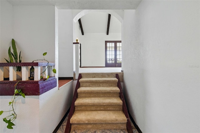11285 8th St E, Treasure Island, FL 33706 - stairway featuring arched walkways, baseboards, and french doors
