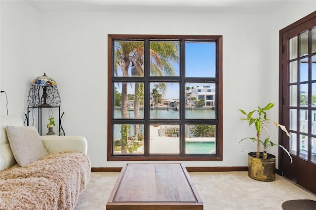 11285 8th St E, Treasure Island, FL 33706 - doorway featuring carpet, baseboards, and a water view