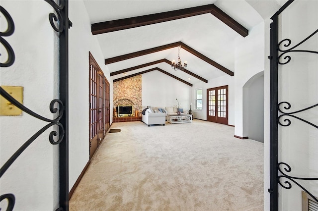 11285 8th St E, Treasure Island, FL 33706 - unfurnished living room featuring beam ceiling, french doors, carpet flooring, a chandelier, and high vaulted ceiling