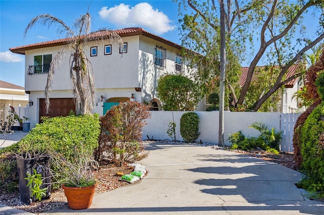 11285 8th St E, Treasure Island, FL 33706 - view of side of home featuring an attached garage, stucco siding, driveway, and a tile roof