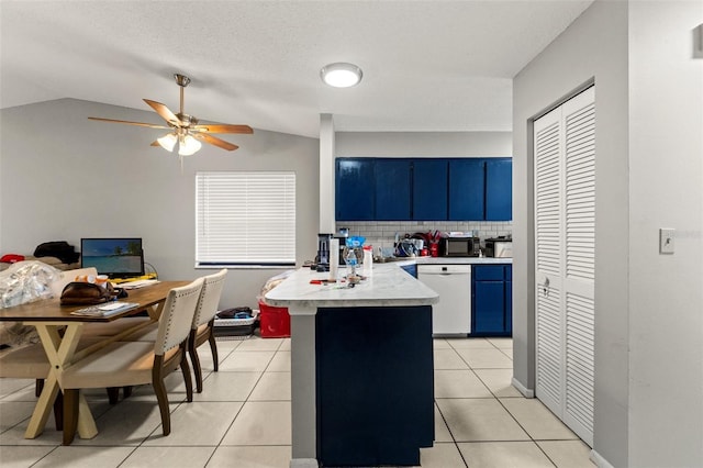 7124 Barclay Ave Unit A, Spring Hill, FL 34609 - kitchen featuring blue cabinets, dishwasher, a peninsula, light countertops, and light tile patterned floors