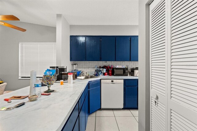 7124 Barclay Ave Unit A, Spring Hill, FL 34609 - kitchen with dishwasher, blue cabinetry, black microwave, a ceiling fan, and light tile patterned flooring