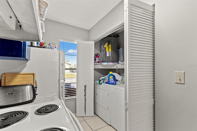 7124 Barclay Ave Unit A, Spring Hill, FL 34609 - kitchen featuring light tile patterned flooring, separate washer and dryer, white appliances, and light countertops