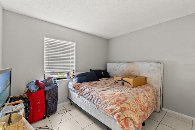 7124 Barclay Ave Unit A, Spring Hill, FL 34609 - tiled bedroom with baseboards and a textured ceiling