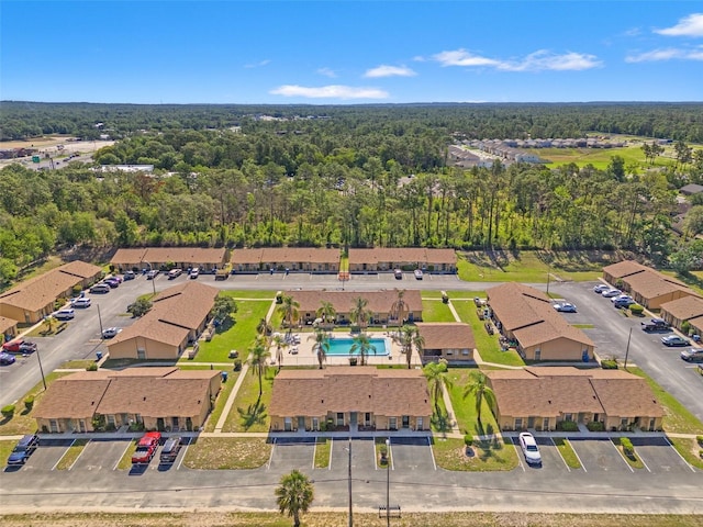 7124 Barclay Ave Unit A, Spring Hill, FL 34609 - bird's eye view of a pool area and a heavily wooded area