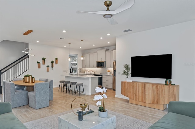 3420 Timber Crossing Ave, Brandon, FL 33511 - living room featuring wood tiled floors, stairs, a ceiling fan, baseboards, and recessed lighting
