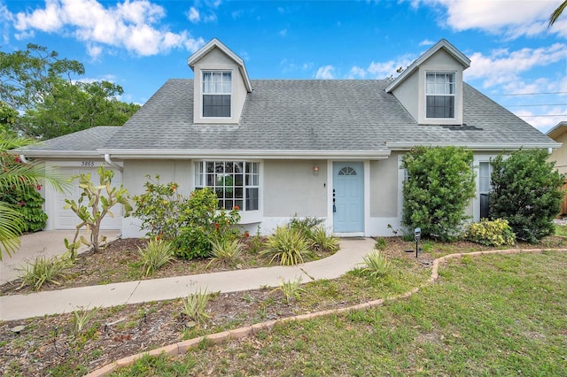 3865 Gatewood Dr, Sarasota, FL 34232 - cape cod-style house featuring stucco siding, a shingled roof, and an attached garage
