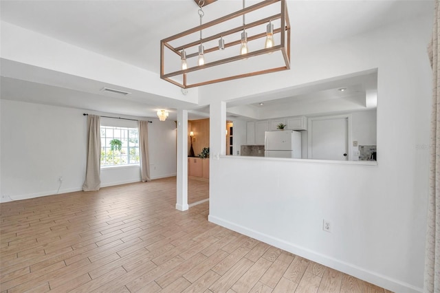 3865 Gatewood Dr, Sarasota, FL 34232 - unfurnished living room with baseboards, wood finished floors, and a raised ceiling