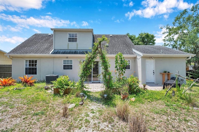 3865 Gatewood Dr, Sarasota, FL 34232 - rear view of house with stucco siding, roof with shingles, and central AC unit
