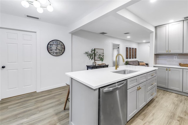 300 33rd Ave N, Saint Petersburg, FL 33704 - kitchen with dishwasher, a sink, gray cabinets, light wood-type flooring, and recessed lighting