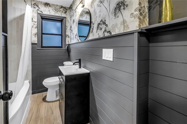 300 33rd Ave N, Saint Petersburg, FL 33704 - full bathroom with wood finished floors, toilet, vanity, wallpapered walls, and shower / bathtub combination with curtain