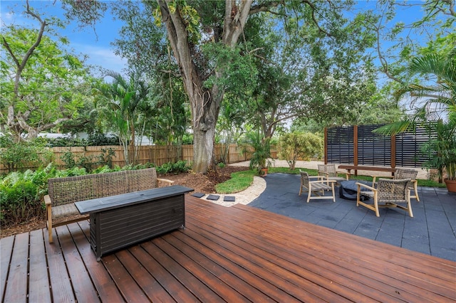 300 33rd Ave N, Saint Petersburg, FL 33704 - wooden deck with an outdoor living space, a fenced backyard, and a patio